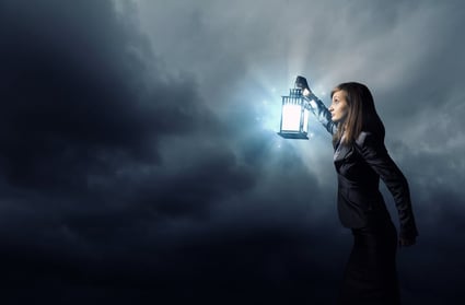 [Image] Woman peering into the mist with a lantern. | Intellectual property due diligence involves searching U.S. patents and trademarks on the USPTO website.